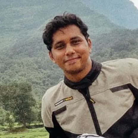 Shahid Shaikh in a riding jacket in the hills